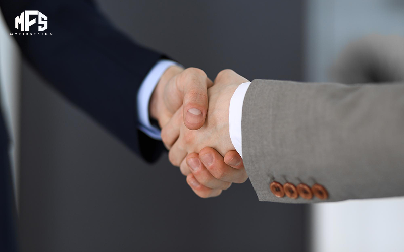 Professional handshake symbolizing a successful business branding partnership.